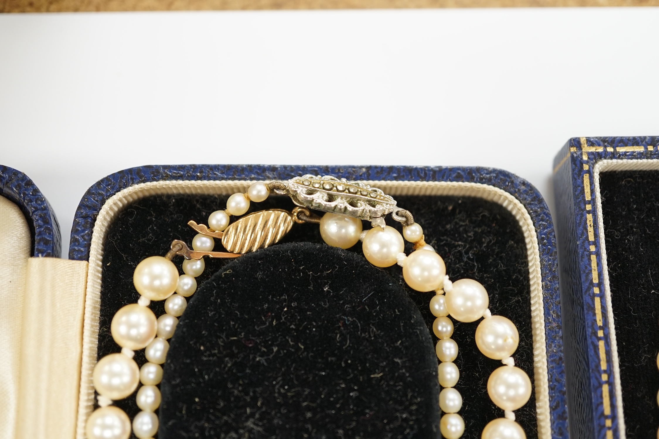 Three assorted cultured pearl necklaces, including two single strand and a double strand with diamond chip set 9ct white gold clasp, 44cm.